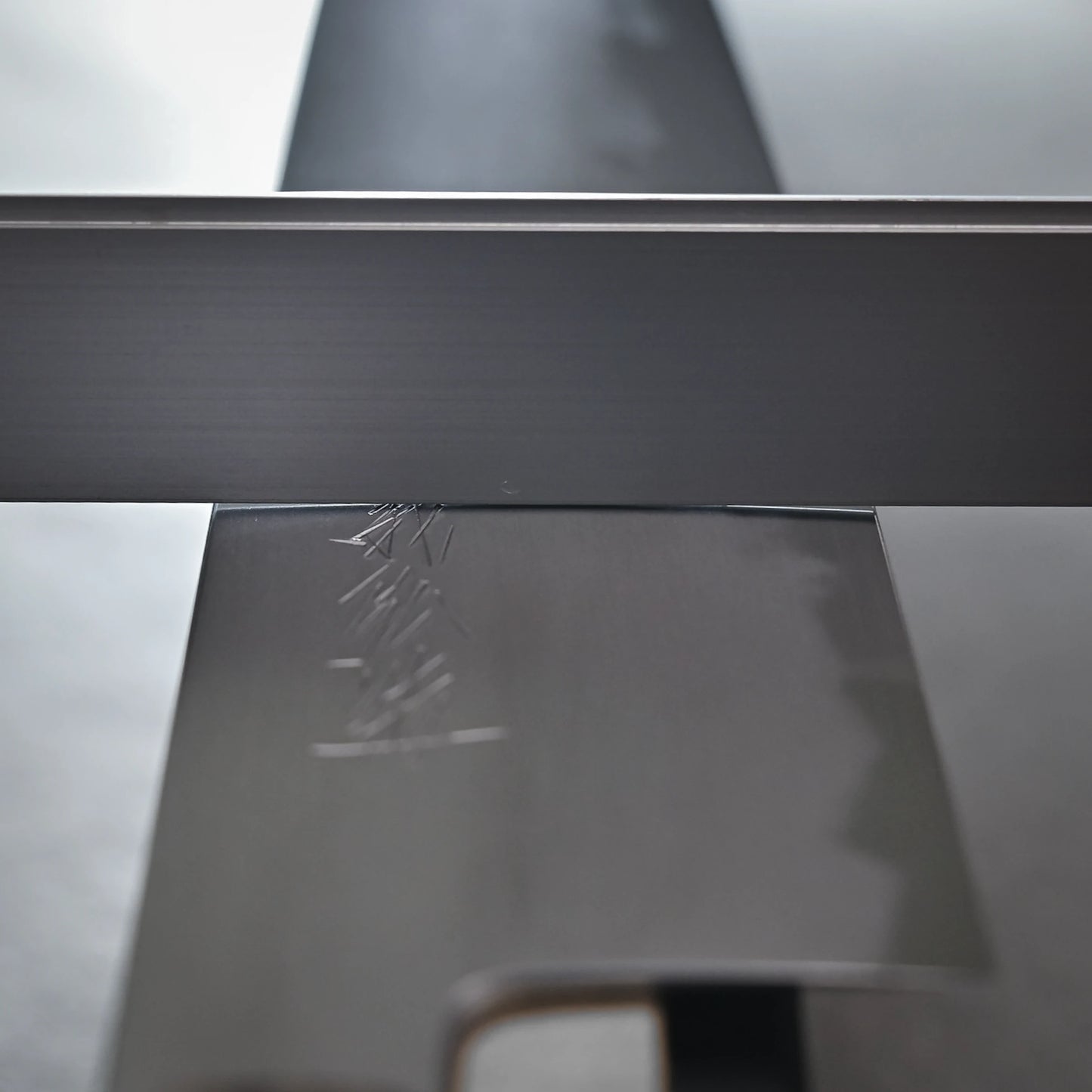 Convexity shown on the Yoshikazu Tanaka shirogami#1 kiritsuke gyuto 225mm blades crossed at an angle, displaying engraved markings and smooth, reflective surfaces crafted by Yoshikazu Tanaka in Sakai, Japan.