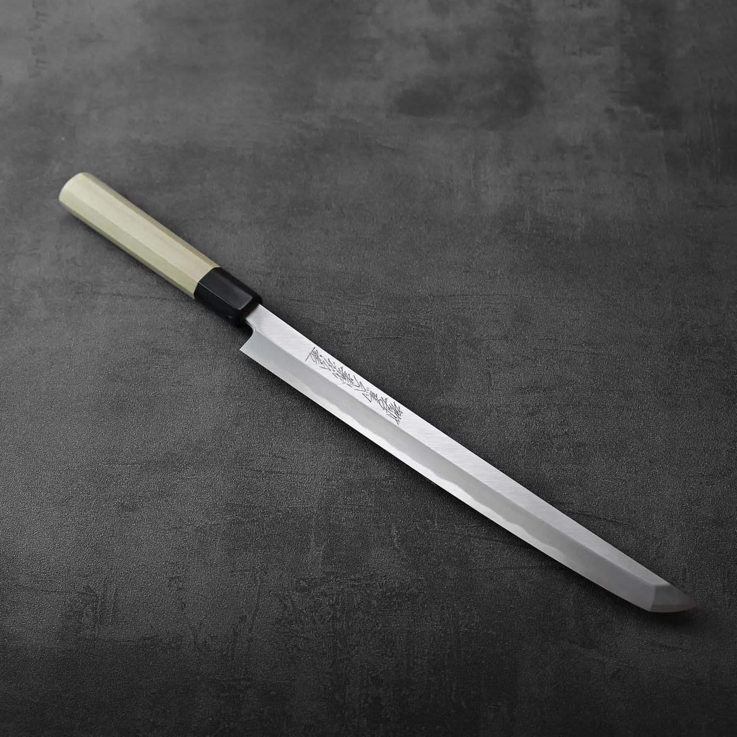 Sakimaru sujihiki with saya, blade is long and gently curved, accompanied by its wooden sheath.