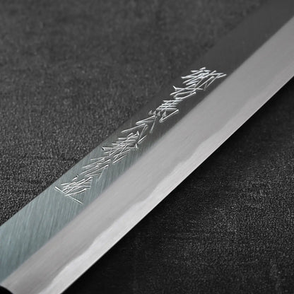 Close-up of a sakimaru sujihiki blade featuring kanji, highlighting the distinct curvature and edge profile.