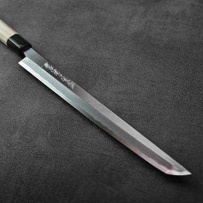 Sakimaru sujihiki with a wooden handle and saya, showing its length and shape, handle detail visible.