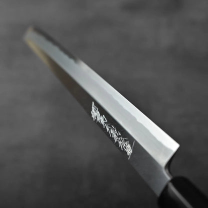 Close-up of a sakimaru sujihiki 300mm knife with saya, highlighting its distinct blade and handle design.