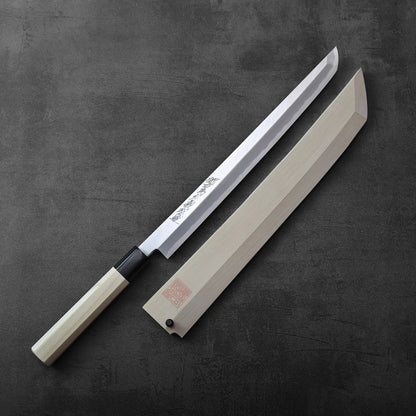 A sakimaru sujihiki 300mm with saya displayed, blade and wooden sheath visible in the composition.