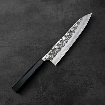 A Yoshimi Kato Hyo SG2 gyuto 210mm with a textured blade and black handle.