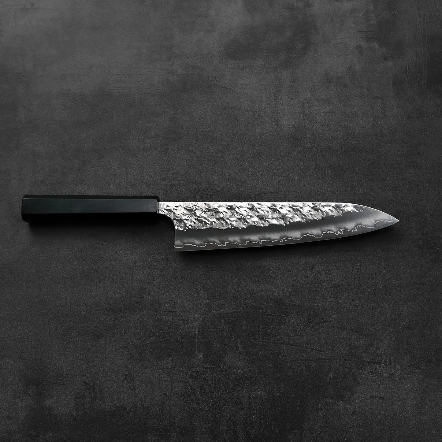 Gyuto with a black handle is shown, highlighting its shape and details without any visible background.