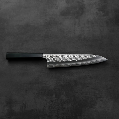 Gyuto with a black handle is shown, highlighting its shape and details without any visible background.