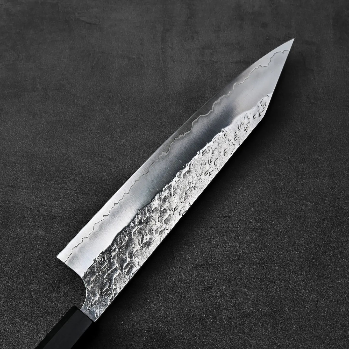 Close-up of a kiritsuke gyuto blade highlighting its 210mm length and detailed finishing.