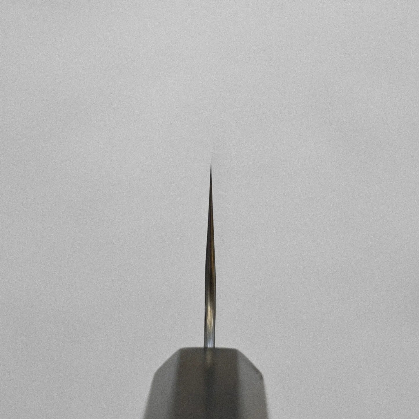 Close-up of kiritsuke gyuto tip with visible details and finish.