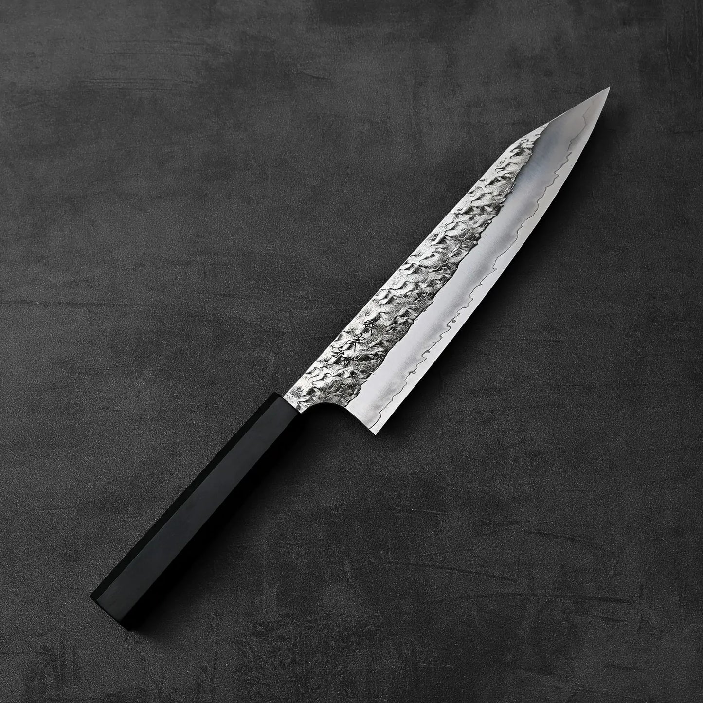 Yoshimi Kato Hyo SG2 kiritsuke gyuto 210mm with a black handle is shown, highlighting its distinct shape and handle color.