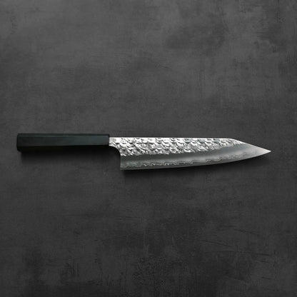 Kiritsuke gyuto with a hammered SG2 blade, black handle, hand-forged in Japan.