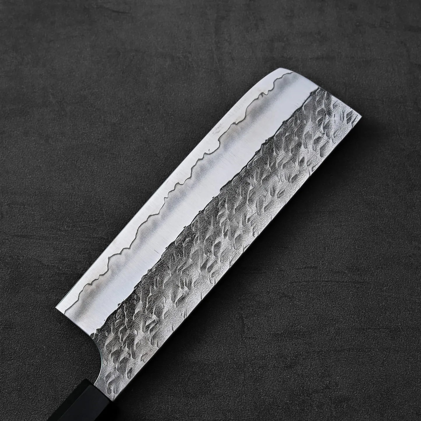 Nakiri with a hammered blade, highlighting its textured finish and detailed metalwork.