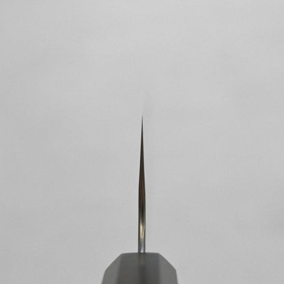 A close-up of a nakiri with a clear view of the blade and handle, highlighting its distinct profile.