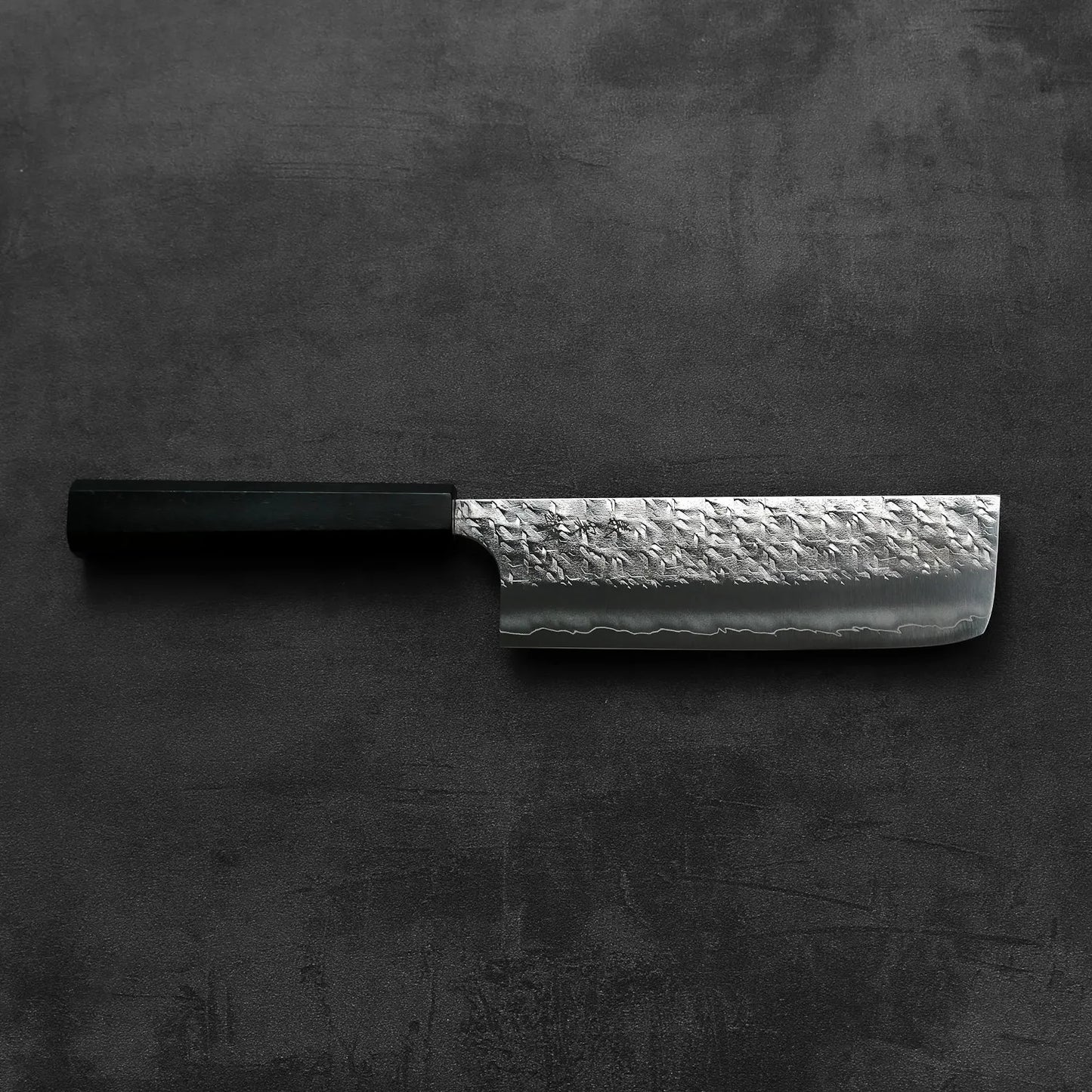 Nakiri with a black handle and a textured blade.