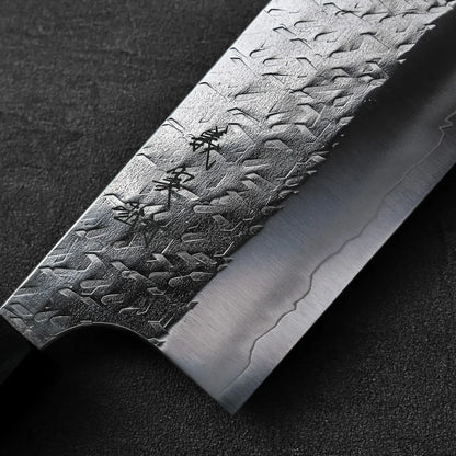 Close-up of the nakiri blade, featuring engraved Japanese characters.