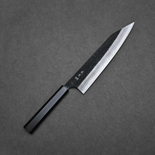 The Yoshimi Kato kurouchi damascus AS kiritsuke gyuto 210mm, a Japanese kitchen knife with a dark handle, sharp textured blade, visible patterns, and Japanese characters near the handle, is crafted from premium Aogami Super steel.