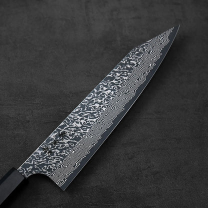 Kiritsuke gyuto with a close-up of its detailed wavy blade pattern visible along the metal.