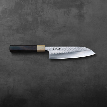Santoku with a patterned blade and dark wood handle, highlighting the textured metal and grain detail.