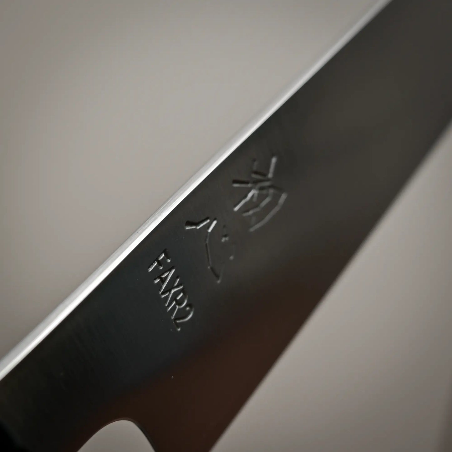 Close-up view of the spine of 270mm Hatsukokoro FAXR2 sujihiki knife