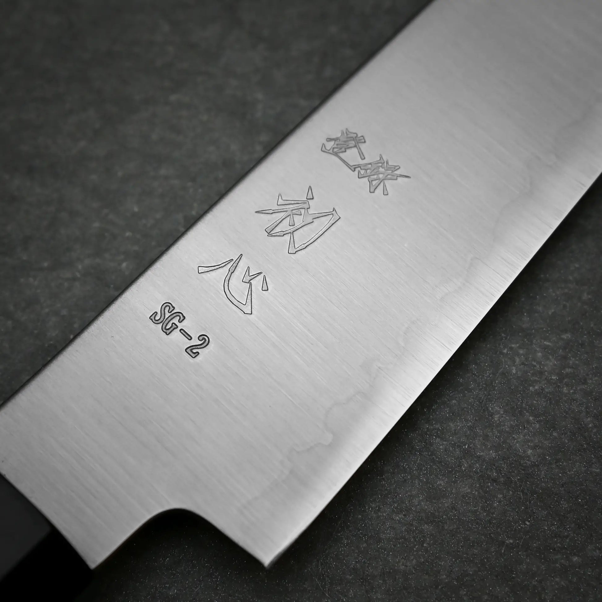 Close-up view of brand mark of 120mm Hatsukokoro Hayabusa SG2 petty knife