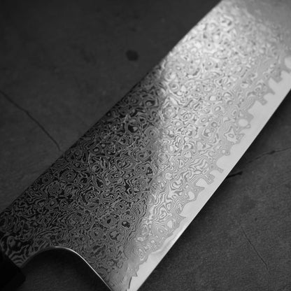 Close up view of the blade of Hatsukokoro ginsan damascus gyuto 210mm. Image focuses on the kanji side of the front blade