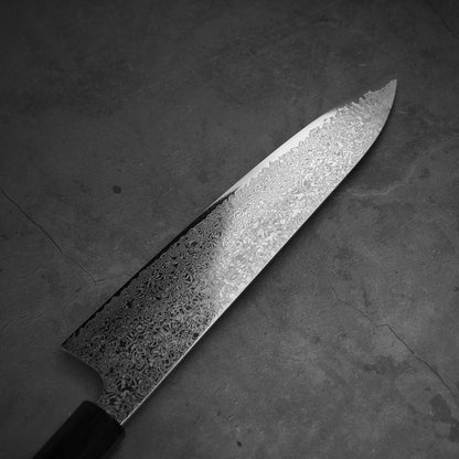 Top view of Hatsukokoro ginsan damascus gyuto 240mm. Image focuses on the left side of the blade.