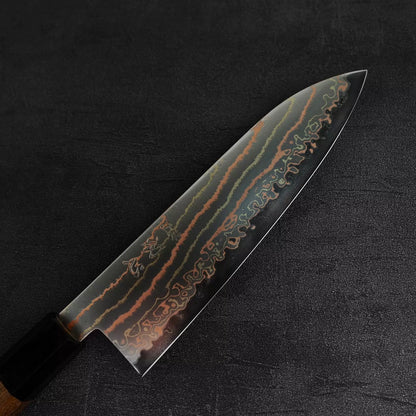 Close up view of the Hatsukokoro Habayusa aogami#2 rainbow damascus santoku knife showing the front side of the blade