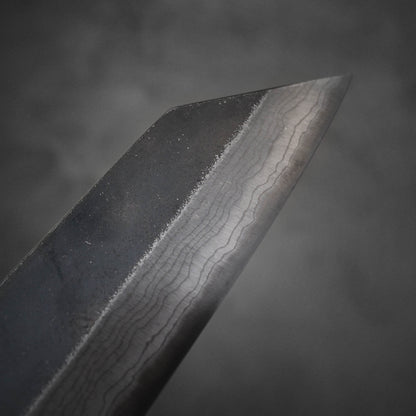 Close up view of Hatsukokoro Kumokage kurouchi damascus aogami#2 bunka knife. Image shows the tip area of the right side of the blade.