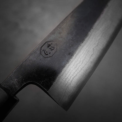 Close up view of Hatsukokoro Kumokage gyuto knife. Image focuses on the kanji side