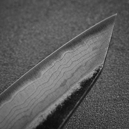 Close up view of the tip area of Hatsukokoro Kumokage kurouchi damascus aogami#2 honesuki knife