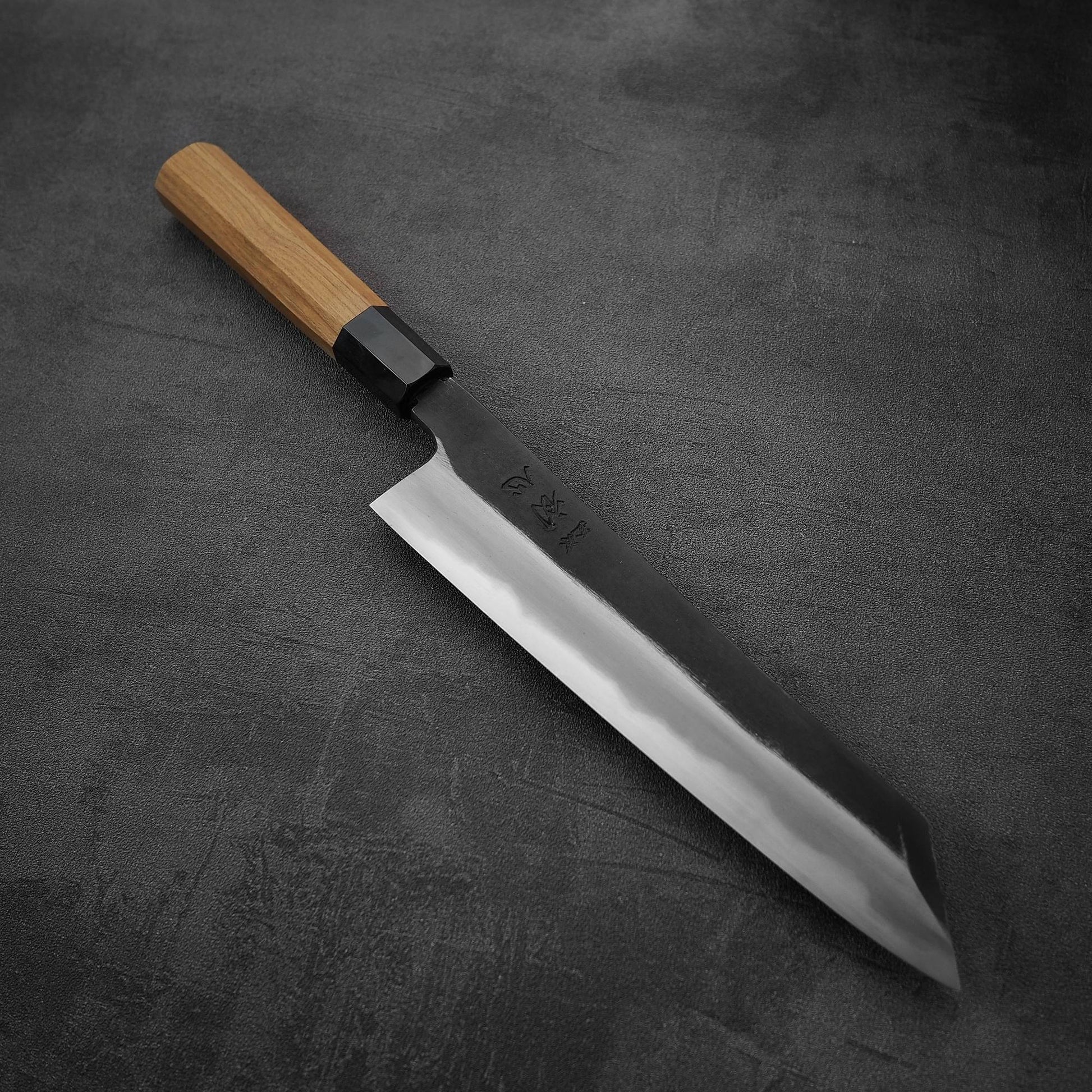 Angled view of Hatsukokoro Yoake kurouchi aogami#1 kiritsuke gyuto knife