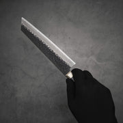 Hand holding Ittosai Kotetsu tsuchime kurouchi aogami super kiritsuke gyuto