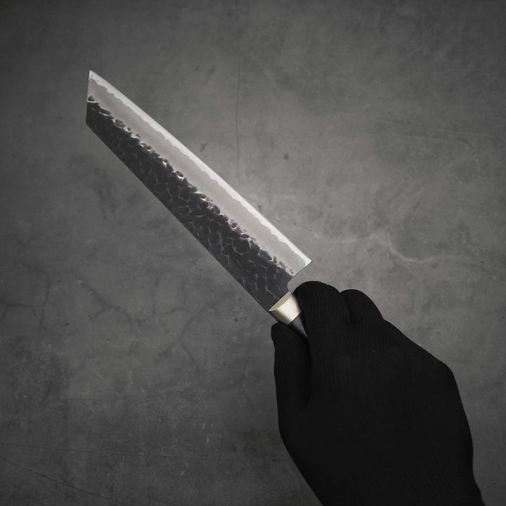 Hand holding Ittosai Kotetsu tsuchime kurouchi aogami super kiritsuke gyuto