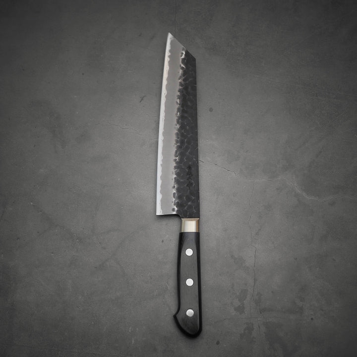 Top view of Ittosai Kotetsu tsuchime kurouchi aogami super kiritsuke gyuto showing the back side of the knife
