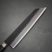 Top view of Ittosai Kotetsu tsuchime kurouchi aogami super kiritsuke gyuto. Image shows the right side of the blade
