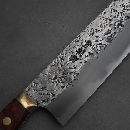 Close up view of 240mm Kisuke Manaka tsuchime honwarikomi shirogami#2 gyuto knife. Image focuses on the kanji area on the right side