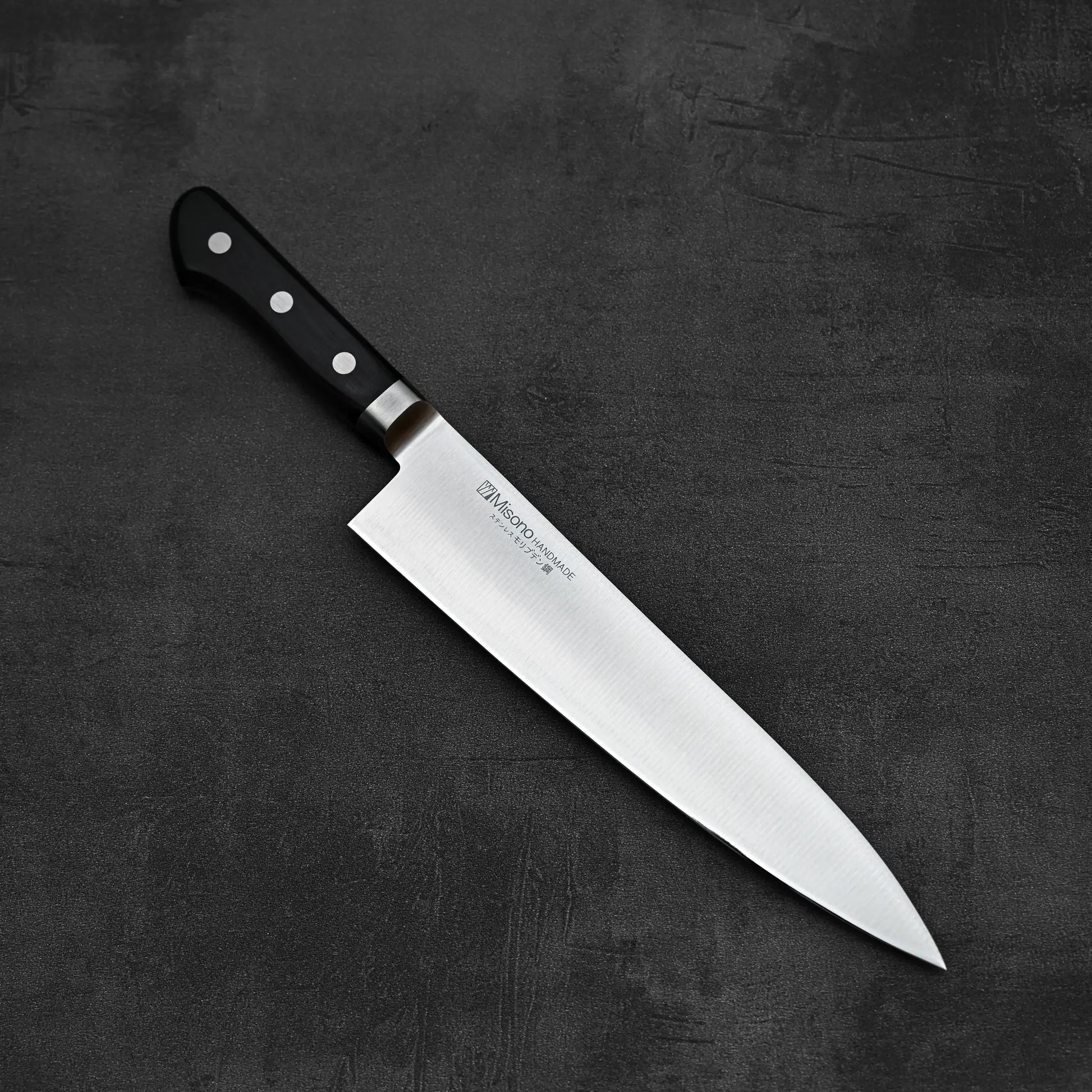 Top down view of Misono molybdenum steel series gyuto knife 240mm in diagonal position where tip is pointing towards lower right