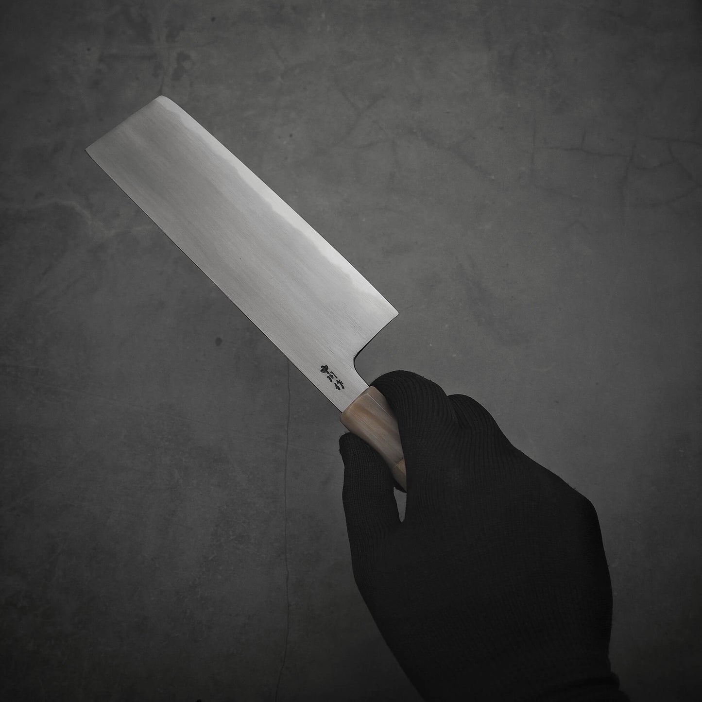 Right hand holding a Nakagawa aogami#2 nakiri knife 