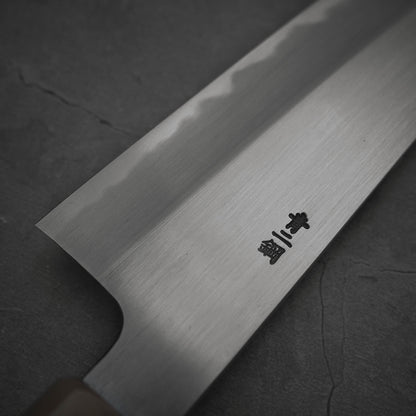 Close up view of the back side of Nakagawa shinogi aogami#2 gyuto knife. Image shows around the heel area