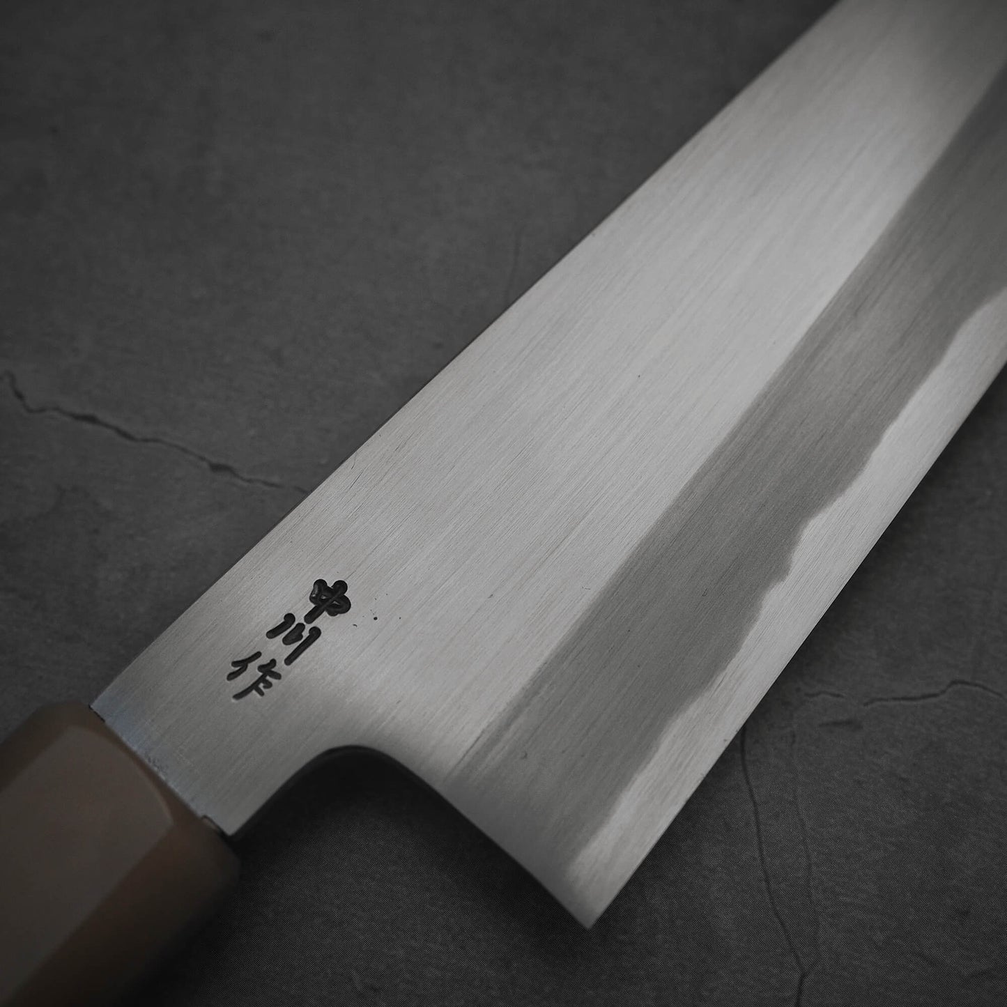 Close up view of the kanji area of Nakagawa shinogi aogami#2 gyuto knife