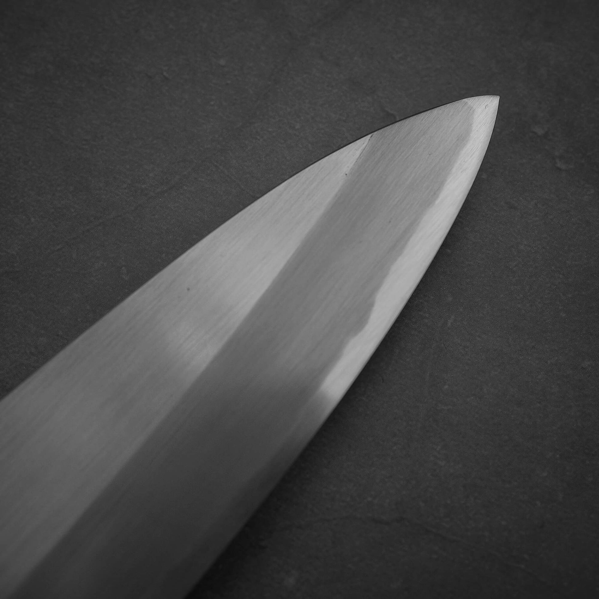 Close up view of the tip area of the Nakagawa shinogi aogami#2 gyuto knife. Image shows the right side