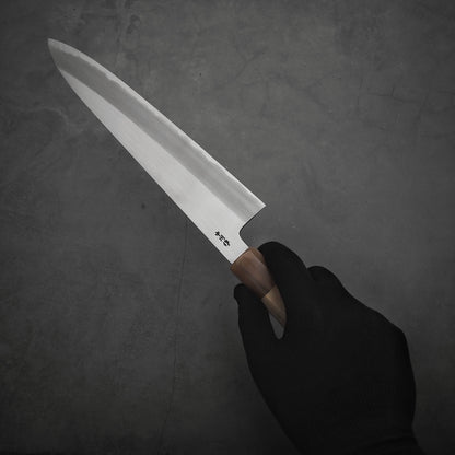 Right hand holding a Nakagawa shinogi aogami#2 gyuto knife