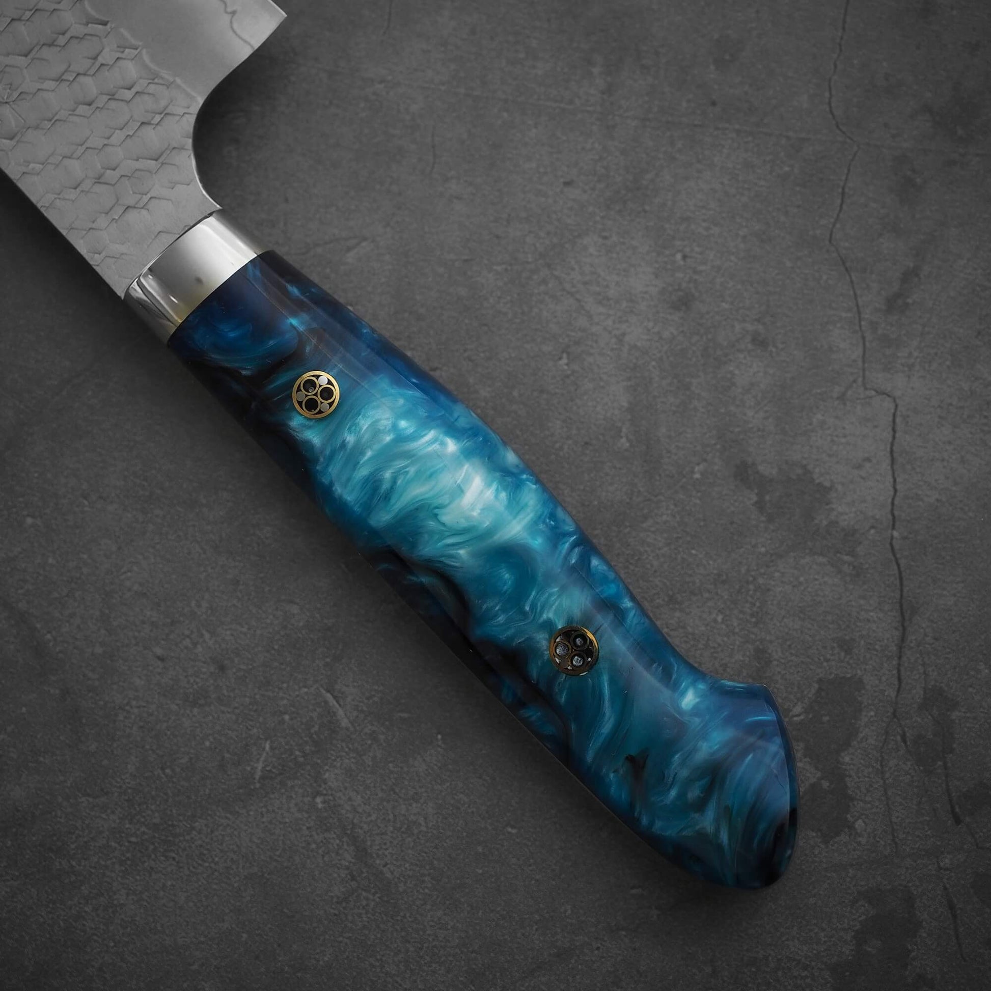 Close up view of the handle of 210mm Nigara tsuchime SG2 gyuto knife with blue handle