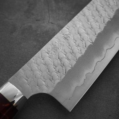 Close up view of the front side of 210mm Nigara tsuchime SG2 gyuto knife with red handle