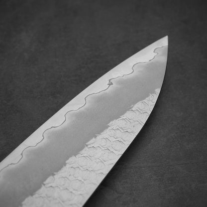 Close up view of the tip area on the other side of 210mm Nigara tsuchime SG2 gyuto knife with pearl handle resin