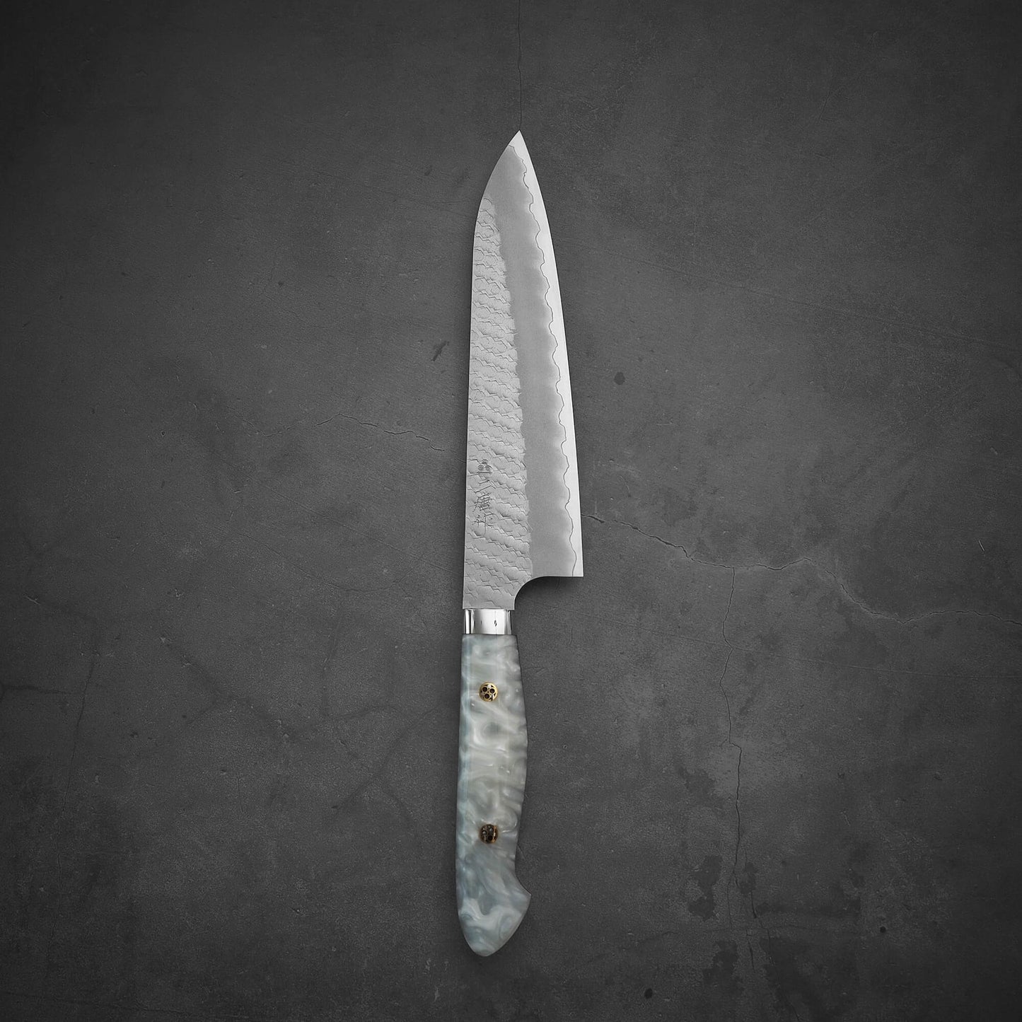Top view of 210mm Nigara tsuchime SG2 gyuto knife with pearl handle resin in vertical position
