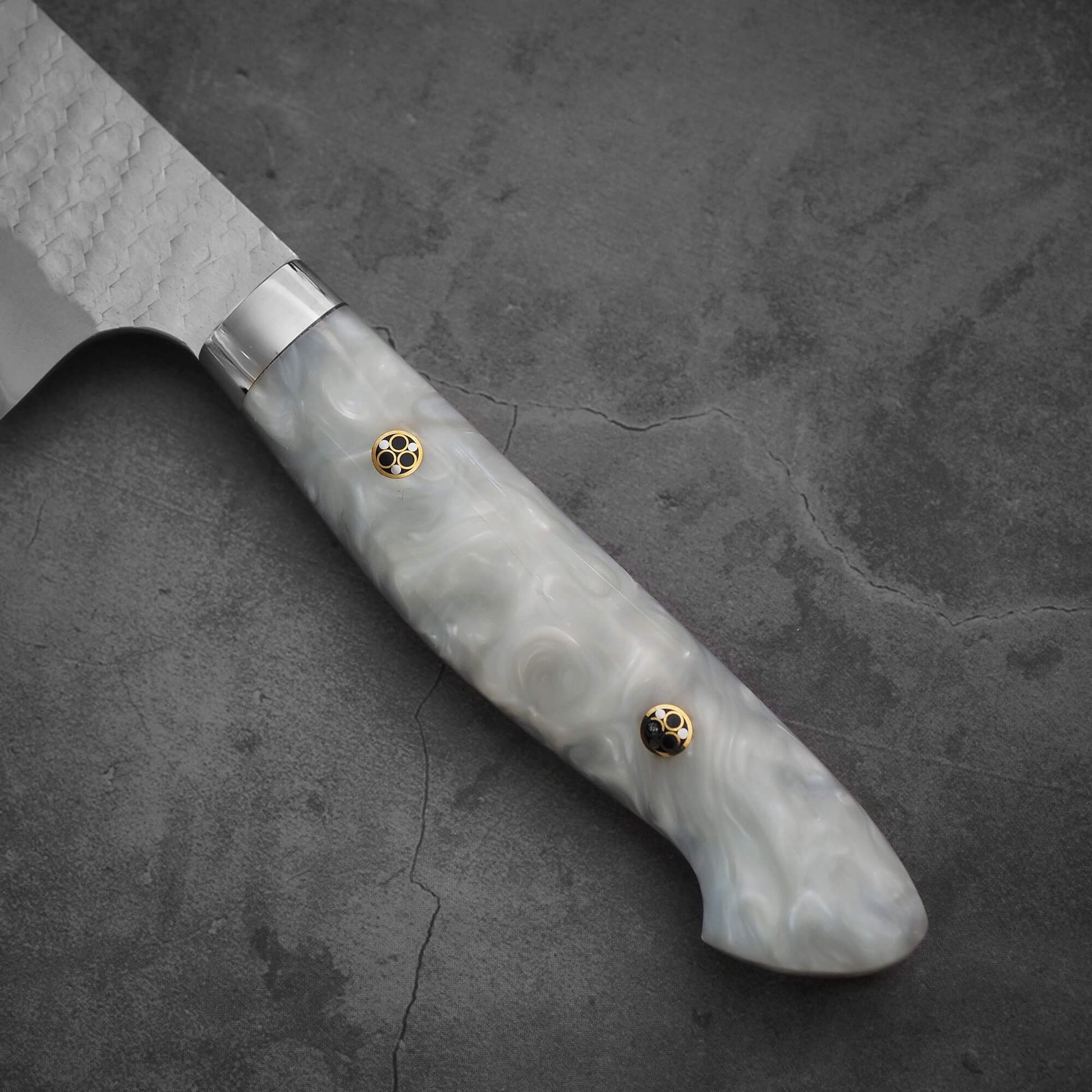 Close up view of the handle of 210mm Nigara tsuchime SG2 gyuto knife with pearl handle resin