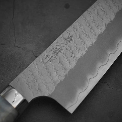 Close up view on the front side of 210mm Nigara tsuchime SG2 gyuto knife with pearl handle resin