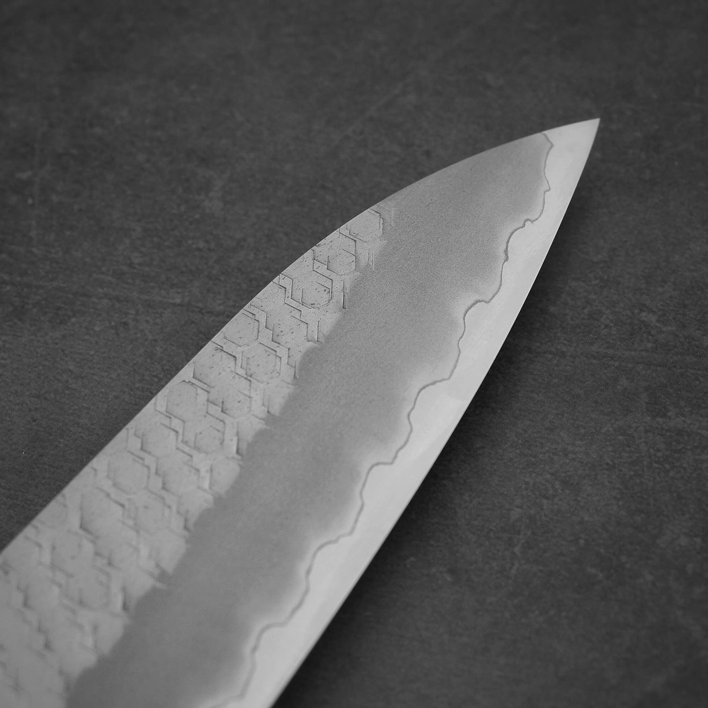 Close up view around the tip area of 210mm Nigara tsuchime SG2 gyuto knife with pearl handle resin