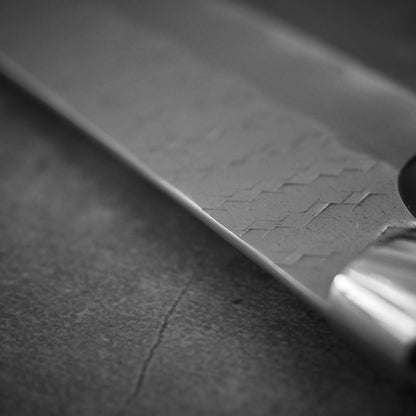 Close up view of Nigara tsuchime SG2 kiritsuke petty knife 150mm showing spine