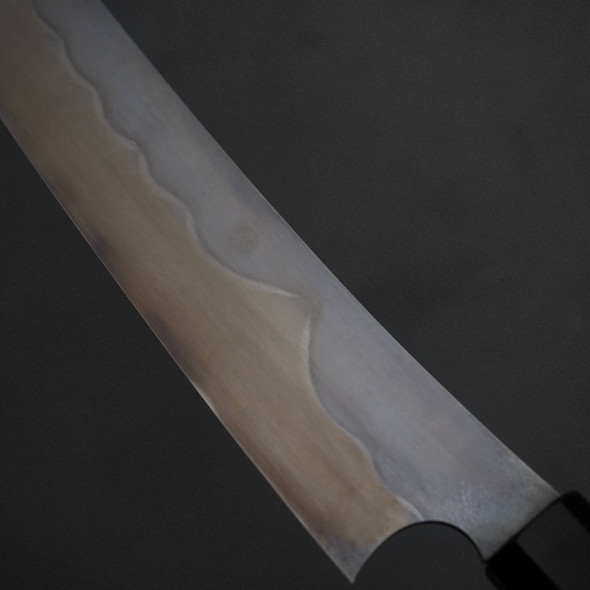 Close up view of Nigara shirogami#1 mizuhonyaki sakimaru yanagiba. Image focuses on the back side of the knife. 