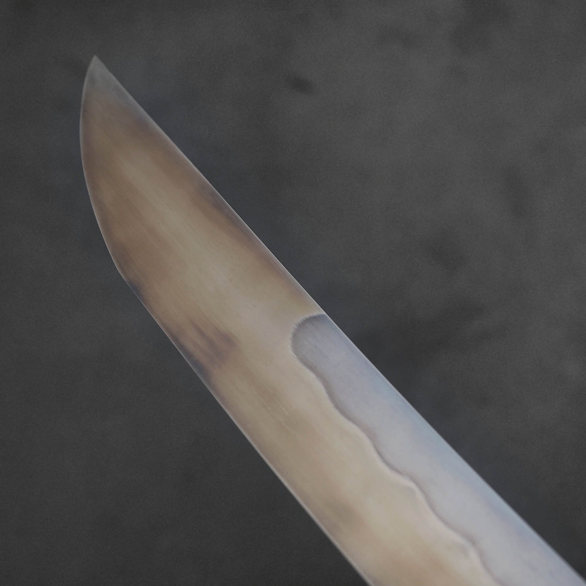 A third close up view of Nigara shirogami#1 mizuhonyaki sakimaru yanagiba. Image focuses on the back side of the knife. 